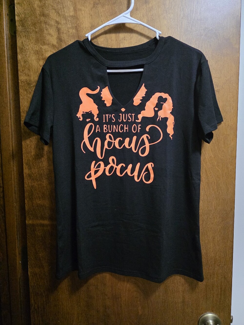 Women’s Black Graphic Tee with Orange Hocus Pocus Print, Key Hole In Front